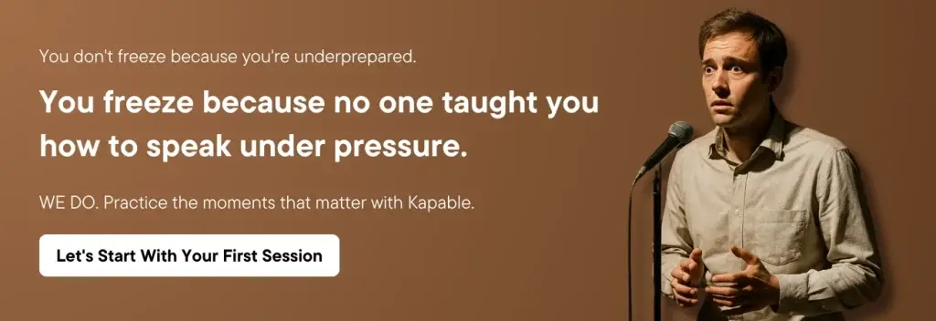 Man speaking on stage with Kapable logo