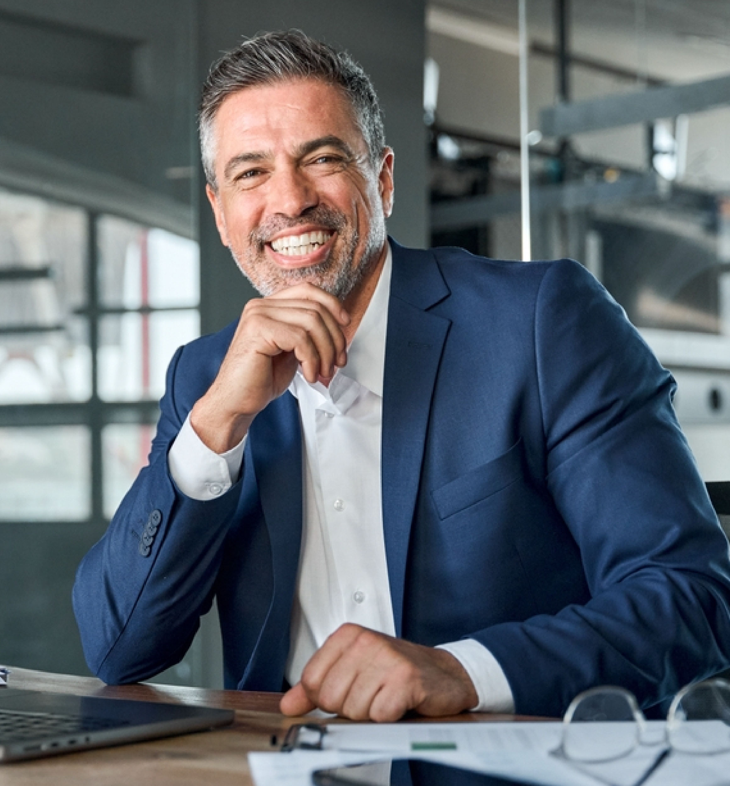 Smiling leader at desk with laptop